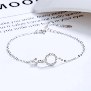Macro detail of S925 sterling silver bracelet featuring a zircon-paved ring and star charm