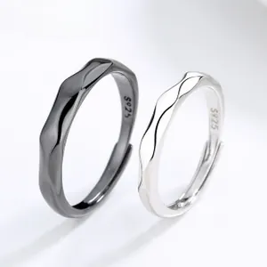 Detail view of wave-textured S925 sterling silver couple rings with adjustable opening