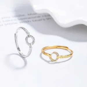 Detail view of adjustable rings in gold and silver finish with pavé set zircon stones