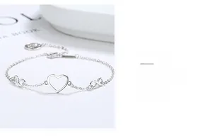 Detail of 925 silver bracelet featuring hollow heart and infinity symbol elements