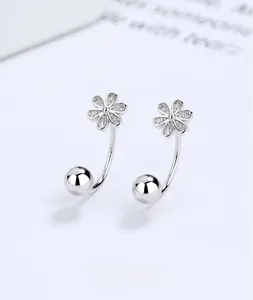 Macro shot of 925 silver U-shaped earrings with threaded screw closure and flower detail