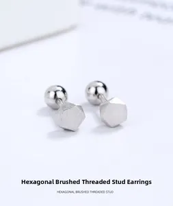Macro view of minimalist S925 sterling silver hexagonal stud earrings with threaded closure