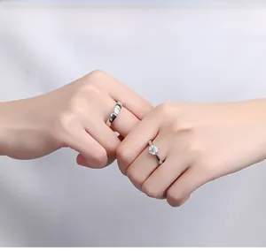 Close-up of elegant six-prong zircon rings on hands for couples in 925 silver finish