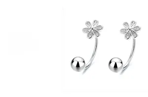 Macro detail of S925 sterling silver U-shaped earring with flower stud and bead
