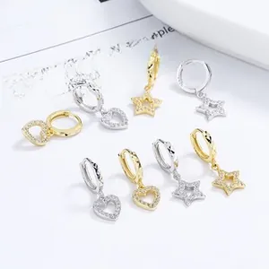 Detailed view of 925 sterling silver heart and star drop earrings with pavé zircon