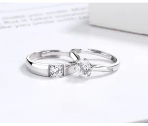 Macro shot of S925 sterling silver couple rings showing six-prong setting and zircon stones