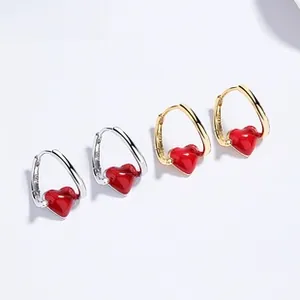 Detailed macro view of S925 sterling silver heart earrings in gold and silver plating