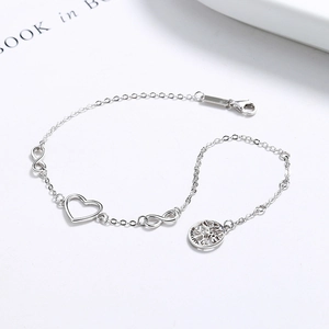 925 silver infinity bracelet with hollow heart and tree of life charms on white background