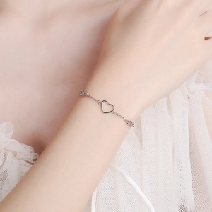 925 silver heart and infinity symbol bracelet shown on a female wrist with lace