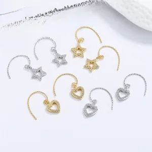 Detailed view of sterling silver star and heart drop earrings with micro-set zircons