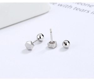 Detailed macro view of S925 sterling silver hexagon stud earrings with screw-back design