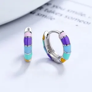 Macro detail of S925 sterling silver hoop earrings with colorful rainbow enamel inlay