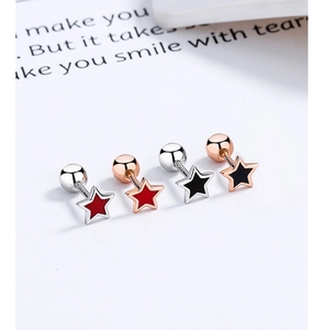 Close-up of S925 sterling silver star stud earrings with colorful enamel and rose gold
