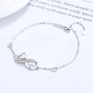 S925 sterling silver infinity heart bracelet with cubic zirconia on white surface