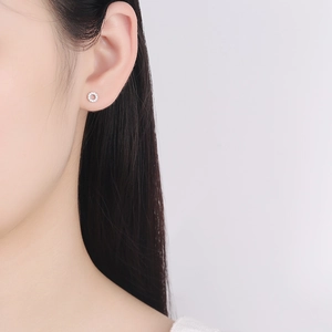 Elegant 925 sterling silver hoop earrings with clear zircons worn by a female model