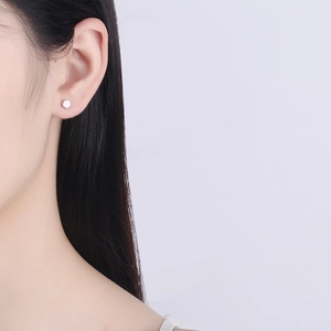 S925 sterling silver hexagonal stud earring with brushed finish on female model