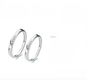 Detailed macro view of S925 sterling silver Amour engraved minimalist couple rings