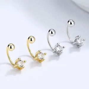 Detailed view of C-shaped screw back earrings with four-prong set cubic zirconia studs