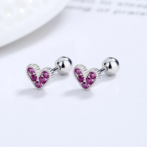 925 silver heart screw back stud earrings with pink cubic zirconia on a white plate
