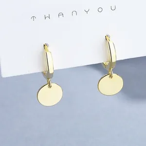 Detailed view of 925 sterling silver minimalist geometric gold hoop earrings on a card