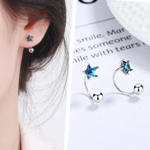Detail of 925 silver U-shape earrings with blue star crystal and spherical screw back