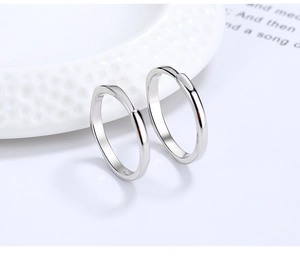 Macro shot of polished S925 sterling silver couple rings with irregular geometric design