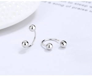 Macro detail of S925 silver horseshoe earrings showing the screw-on ball and inner thread