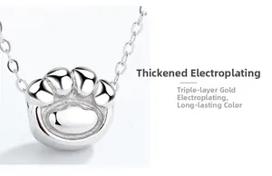 Macro view of S925 silver cat paw pendant showing thick gold plating for long-lasting color