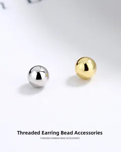 Macro detail of polished gold and silver threaded earring beads for DIY jewelry making