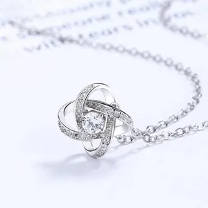 Macro detail of 925 sterling silver four-leaf clover necklace with sparkling cubic zirconia