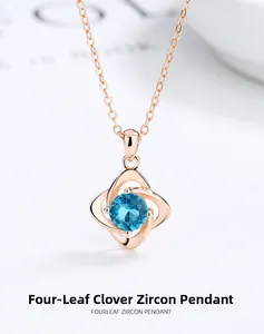 Detail of rose gold four-leaf clover pendant featuring a sky blue round zircon stone