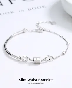 Detail of S925 silver bracelet with small waist bead and geometric charms on white background