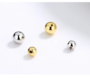 Detailed macro view of S925 sterling silver threaded bead replacements in gold and silver