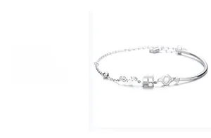 Macro detail of S925 sterling silver hourglass cylinder link and adjustable chain bracelet