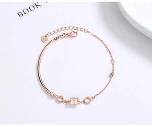 Detail of rose gold bzero1 style bracelet with cylindrical bead and heart charm