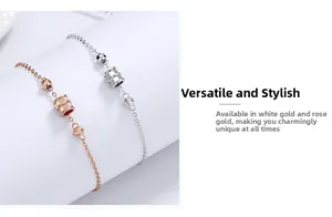 Detail of rose gold and silver minimalist thin chain bracelets with cylindrical beads