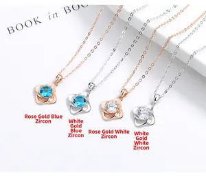 Detailed close-up of four-leaf clover necklaces in rose gold and silver with zircon
