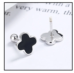 Macro shot of 925 sterling silver clover studs with black inlay and secure screw back