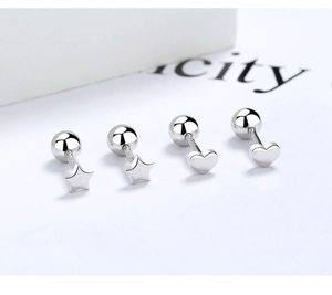 Detail view of silver 925 star and heart stud earrings with round screw backs