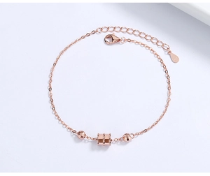 Detail of rose gold S925 sterling silver chain bracelet with textured cylindrical beads