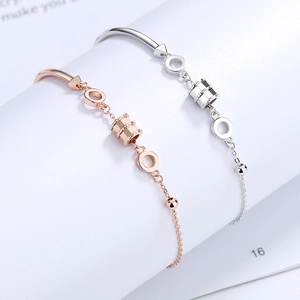 Elegant S925 sterling silver bangle with rose gold cylinder pendants and sleek chain link