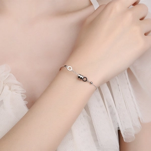 Elegant S925 sterling silver hourglass bracelet on wrist with refined jewelry details