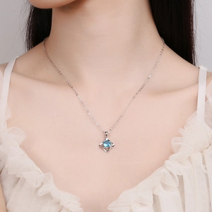 Elegant 925 sterling silver necklace featuring a blue round gemstone pendant on a model