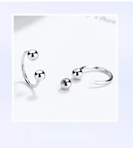 Macro detail of S925 sterling silver U-shaped earring with screw thread design and silver beads