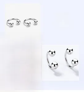 Polished silver U-shaped horseshoe earrings with screw-on round beads in a detailed view