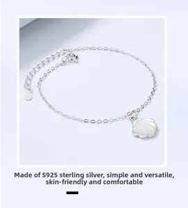 Macro detail of S925 sterling silver chain with white mother-of-pearl shell charm