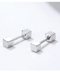 Macro shot of silver cube stud earring with S925 hallmark on minimalist barbell