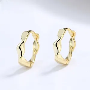 Detail of gold twisted rope hoop earrings with s925 silver core and secure snap closure