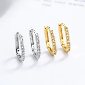 Detail of silver and gold U-shaped hoop earrings with micro-paved cubic zirconia stones
