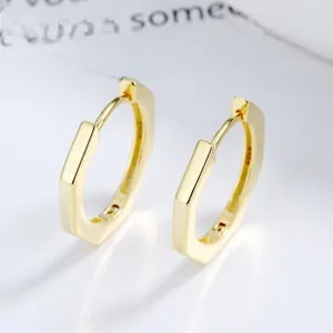 Close-up of S925 hallmark on gold hexagonal hoop earrings with minimalist design